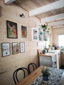 a kitchen with wooden walls and a table and chairs at Domki Między Drzewami in Bartoszylas +70 photos