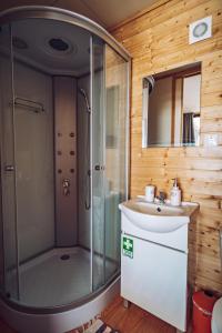 a bathroom with a shower and a sink at Calheta Glamping Pods - Nature Retreat in Calheta