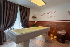 a spa room with a bench and a sign on the wall at Hotel Europa in San Martino di Castrozza