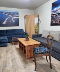 a living room with a couch and a table at Apartament w Porcie Kołobrzeg latarnia morska plaża molo w zasięgu ręki in Kołobrzeg