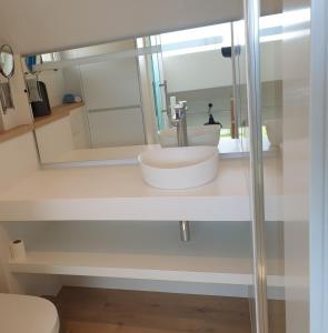 a bathroom with a sink and a mirror at Duinengolf 5 in Middelkerke