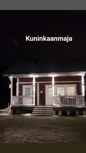 a house with lights on the front of it at night at Purolomat in Merikarvia