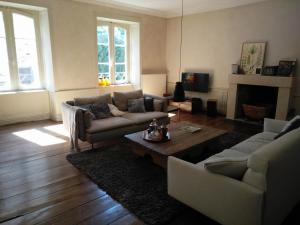 a living room with a couch and a coffee table at casalodge appartement de charme 145 M2 in Dinan