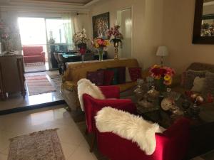a living room with two couches and a table at Hotel Pousada Irmaos Freyhardt in Rio de Janeiro