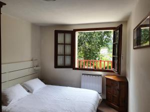 a bedroom with a bed and a window at 3 Allée de l'Orée du Lac in Biarritz