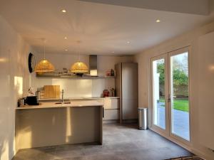 a kitchen with a sink and a counter top at De Egel in Oostkapelle