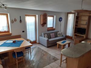a living room with a couch and a table at Appartamento 3cime Stefania in Padola +4 photos