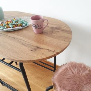 a table with a coffee cup and a plate of food at Studio apartman Promenada in Sarajevo
