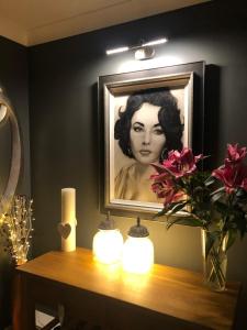 a picture of a woman on a table with candles at Clocktower Suite in Exeter