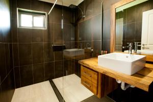 a bathroom with a white sink and a mirror at Stirling Estate Chalets in Capel +44 photos