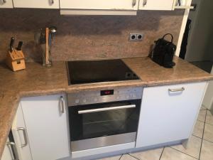 a kitchen with a stove and a counter top at 4 Zimmerwohnung zentrale Lage in Wendeburg