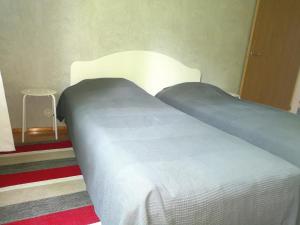 a bedroom with a bed with a white head board at Двухкомнатные просторные апартаменты. in Imatra