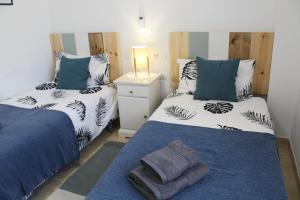 a bedroom with two beds with blue and white at BEACH FOREST PARADISE in Cabopino +37 photos