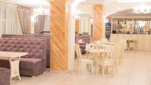 a dining room with tables and chairs in a restaurant at Mountain Lift 7 Hotel in Bukovel