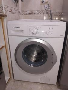 a washing machine with a metal object in a room at La Perla in Mar del Plata
