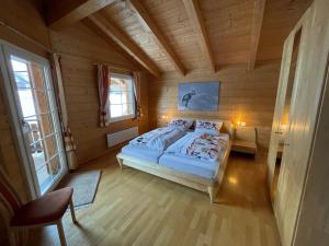 ein Schlafzimmer mit einem Bett in einem Zimmer mit Holzwänden in der Unterkunft Chalet Inge in Saas-Fee