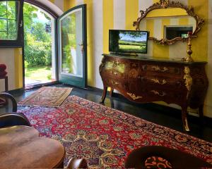 a living room with a dresser and a mirror at Villa Doris in Berchtesgaden