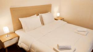 Katil atau katil-katil dalam bilik di Uni Island - City Center Suites