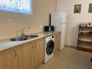 a kitchen with a sink and a refrigerator at Apartamento Martín in Ardales