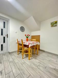 a dining room with a table and chairs at Apartmán Klaudia in Ružomberok +11 photos