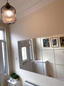 a large mirror in a kitchen with a refrigerator at Large House Near Anfield & Liverpool Town in Liverpool