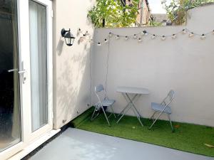 a small patio with two chairs and a table at Large House Near Anfield & Liverpool Town in Liverpool