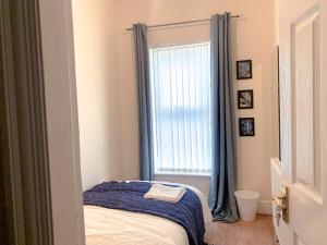 a bedroom with a bed and a window at Large House Near Anfield & Liverpool Town in Liverpool