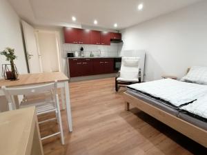 a living room with a bed and a kitchen at Filder-Apartment in Filderstadt