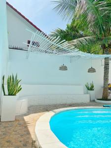 a swimming pool with a hammock in a house at Room in Vung Tau- Blue Fish Deluxe Room- Phòng Bãi Sau Vũng Tàu in Vung Tau