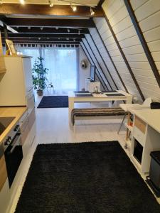 an attic room with a desk and a table at Haus Eifel in Kerschenbach