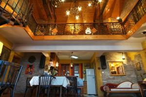 a dining room with a table and a balcony at Casa de Artes Guest House in Balchik