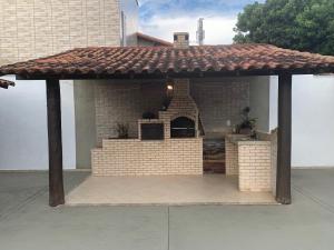 a patio with an outdoor grill in a house at Kitchenette near the Beach/including Breakfast in Búzios