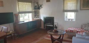 a living room with a couch and a table at Montes de Baixo in Odeceixe