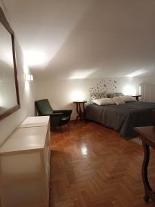 a bedroom with a bed and a desk and a chair at La Crisalide in Sorano