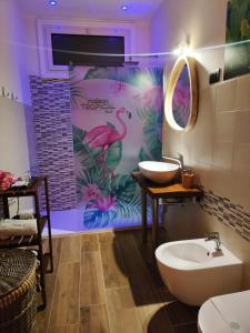 a bathroom with a pink flamingo mural on the wall at Suite Maison Tropical - Luxury Apartment in Central Bari in Bari
