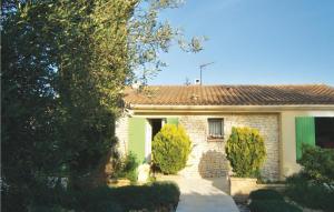 a brick house with a green door and trees at 3 Bedroom Beautiful Home In Boulbon in Boulbon