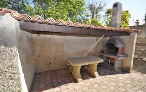 a patio with a bench and an outdoor oven at Nice Home In Saint Cannat With Wifi in Saint-Cannat