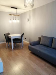 uma sala de estar com um sofá e uma mesa em Apartament w Centrum em Szczecin