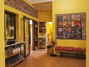 a room with a yellow wall with a bench in it at Mai Home Ninh Bình in Ninh Binh