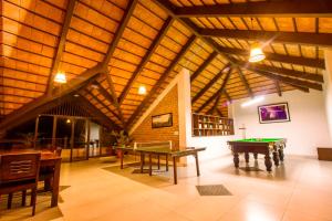 a room with two ping pong tables in a building at Machaan Plantation Resort, Sakleshpur in Sakleshpur