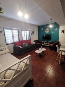 a living room with a couch and a tv at DEPARTAMENTO a 5 cuadras de la Av Aristides - Ubicacion super privilegiada in Mendoza