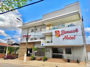 a building with a sign for a burger hotel at Baruch Hotel in Araguaína