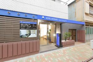 a blue and white building with a blue door at HOTEL MYSTAYS Ueno Iriyaguchi in Tokyo