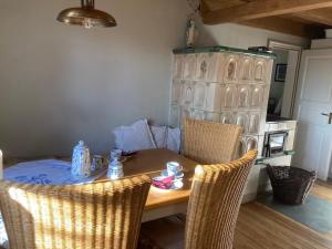 a dining room table with two chairs and a table and chairsktop at Haus Nr. 9 in Ruppichteroth +8 photos