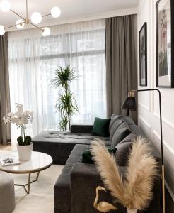 a living room with a couch and a table at Lolita Lux - Belgrade Waterfront in Belgrade +58 photos