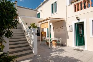 a staircase leading up to a house with a table at La belle Hélène in Spetses