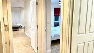 a door leading into a room with a bedroom at Holiday Flat in Central Slough near to London Heathrow and Windsor with Free Car Park in Slough