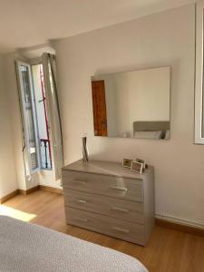 a bedroom with a dresser with a mirror on the wall at Appartamento Ca' Baci' in Pigna