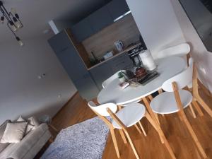 a living room with a table and four chairs at Bjelašnica mountain view apartment in Bjelašnica +9 photos