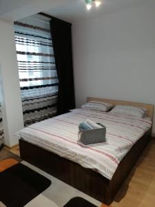 a bed with a purse sitting on top of it at Iris Vivo Mall in Cluj-Napoca